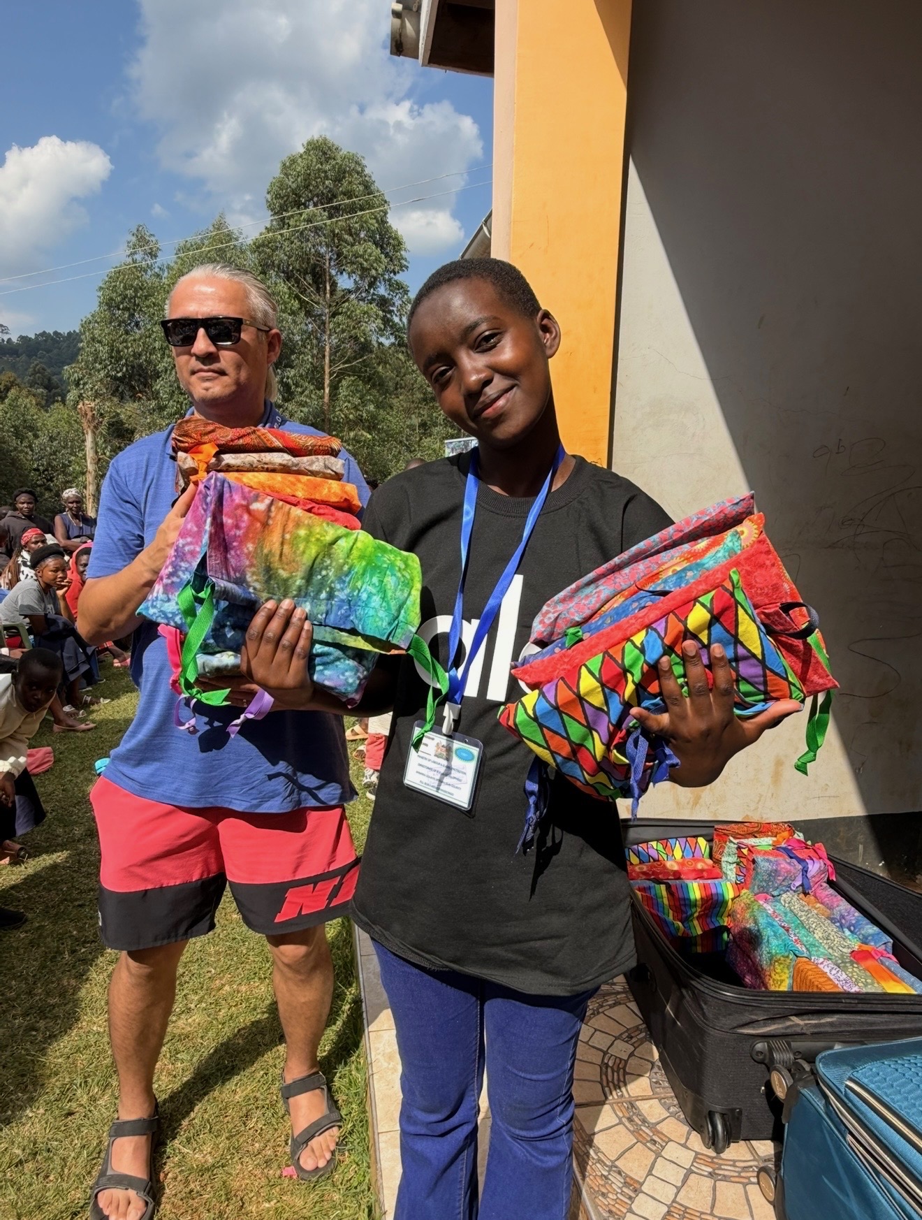 Life Together Alliance team members carrying colorful DignityKits for distribution