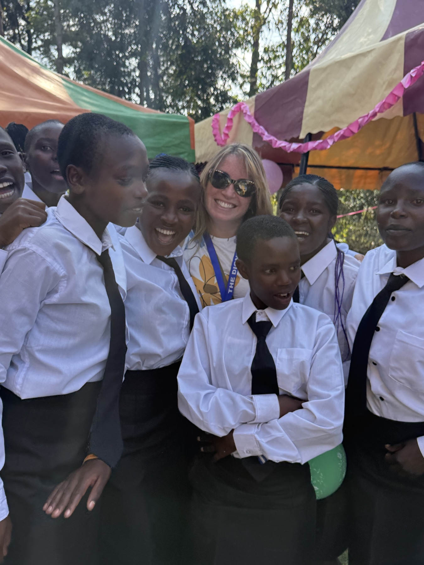A Life Together Alliance team member sharing a joyful moment with students