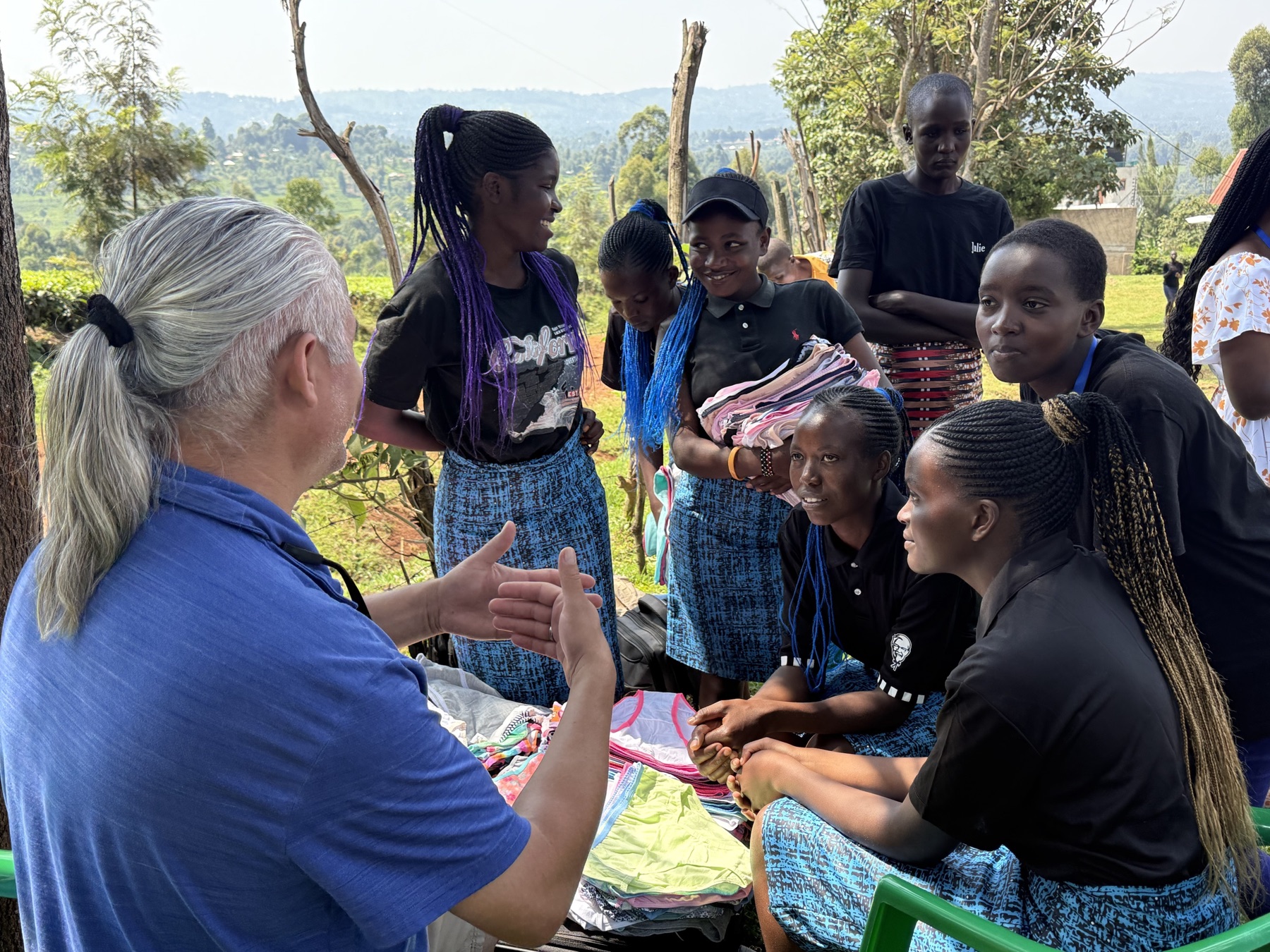 A Life Together Alliance supporter talking with girls during a community gathering