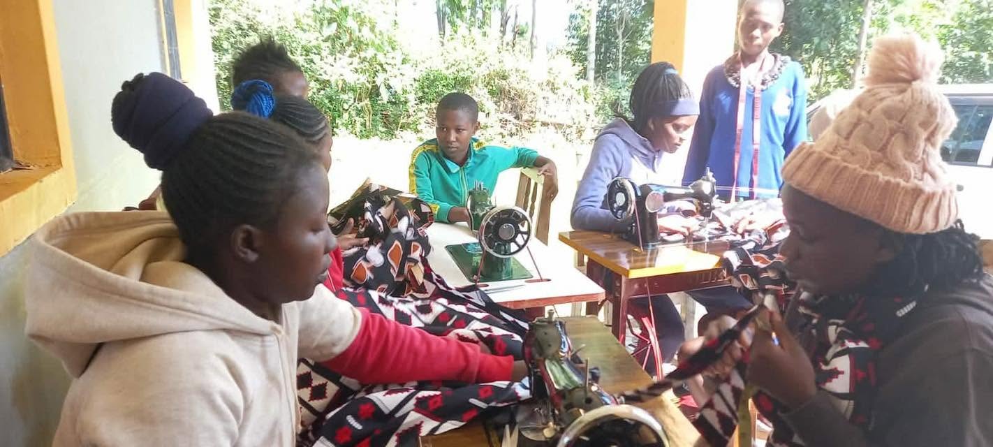 Young women practicing sewing skills